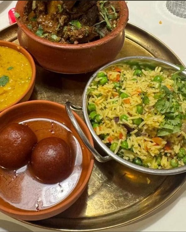 A thali of lamb curry, dal, vegetable pulao and gulab jamun